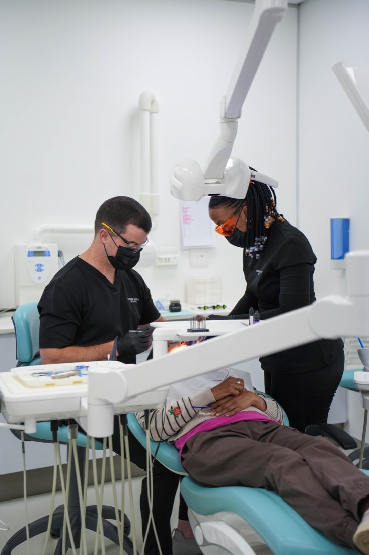 Dr Alberts and assistant with a patient at Melrose Dental Studio